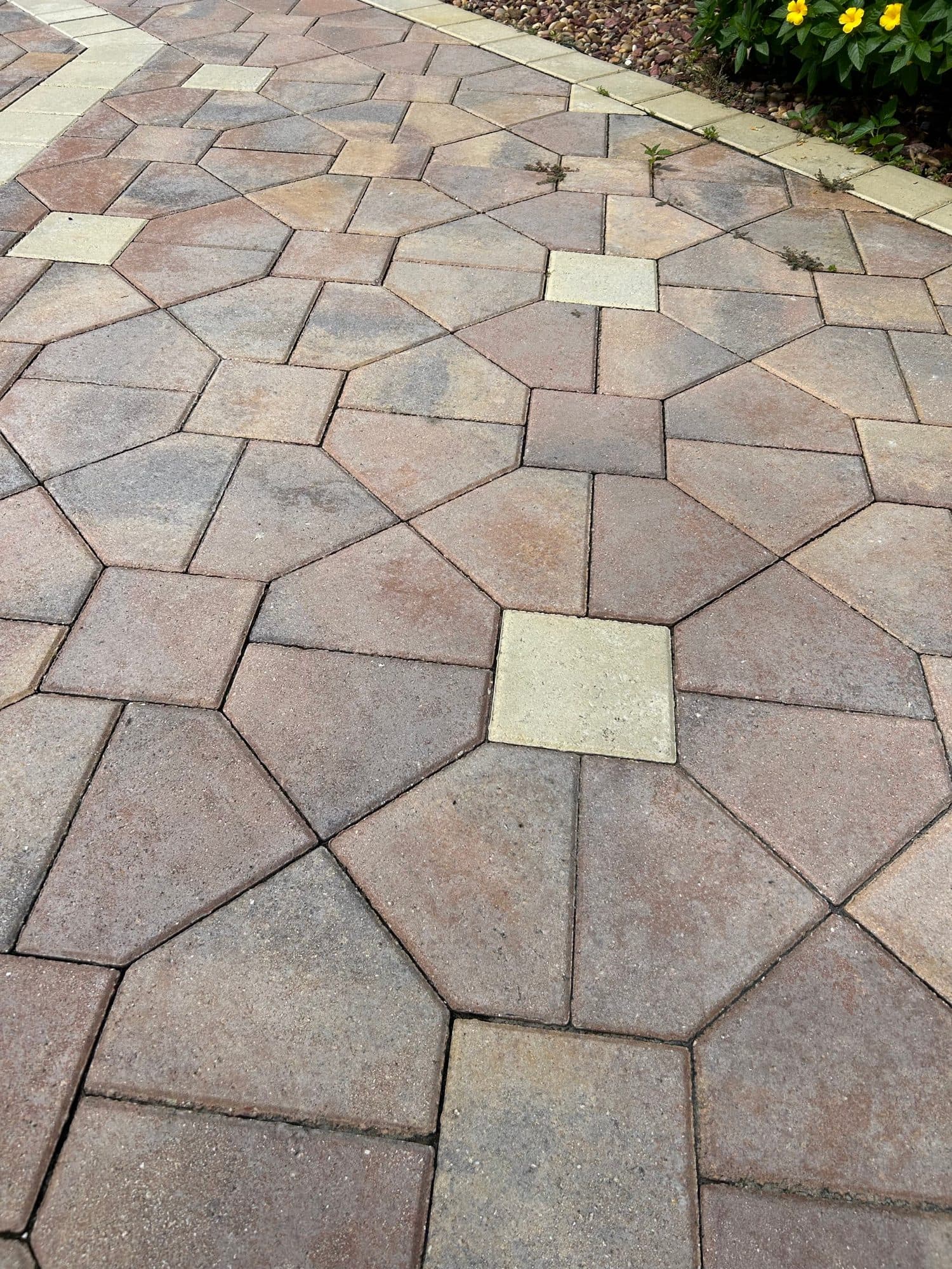 Restored geometric paver walkway with decorative accents in Brevard County, FL — paver repair and restoration by Atlantic Exteriors